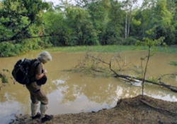 Belinda marking elephant tracks beside a pond